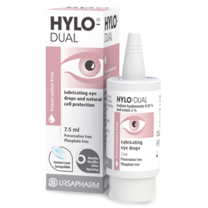 Image of a 10ml bottle of Hylo-Dual Eye Drops, a solution for treating itching and redness in the eyes caused by allergies. The packaging indicates that the product is preservative-free, phosphate-free, and suitable for contact lens users, with a 6 months sterility after opening. The bottle and its box are predominantly white with pink accents and black text. There is also a logo that reads ‘URSAPHARM’ at the bottom of the box