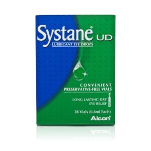 A box of Systane UD Lubricant Eye Drops. The packaging is predominantly blue and green with a large white and green ‘Systane’ logo at the top. Below the logo, in smaller white text, ‘UD’ is printed, followed by ‘Lubricant Eye Drops’ in larger font. A tagline reads ‘Convenient Preservative-Free Vials.’ Additional information includes ‘Long Lasting Dry Eye Relief,’ and the quantity is specified as ‘28 Vials (0.8ml Each).’ The Alcon logo appears at the bottom right corner, indicating the brand. The overall design features a graphic of a single eye drop on a leaf, symbolizing the natural relief aspect of the product.