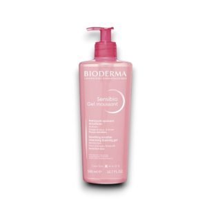 Bioderma Sensibio Gel Moussant in a 500ml (16.7 FL.OZ.) pink transparent bottle with a red pump dispenser. The label displays the 'Bioderma' logo at the top, with the product name 'Sensibio Gel Moussant' in white text. The description highlights it as a soothing micellar cleansing foaming gel that moisturizes the skin, suitable for the face and eyes, and designed for sensitive skin. The 'NAOS' logo is positioned at the bottom, with additional product details in both French and English.