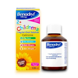 Benadryl Allergy Children's 2+ Oral Solution 120ml, featuring cetirizine 1mg/ml, sugar and colour free, in a brown medicine bottle with a white cap, shown alongside its bright yellow and blue packaging decorated with a sunflower and icons for hay fever, pet, dust, and skin allergies.
